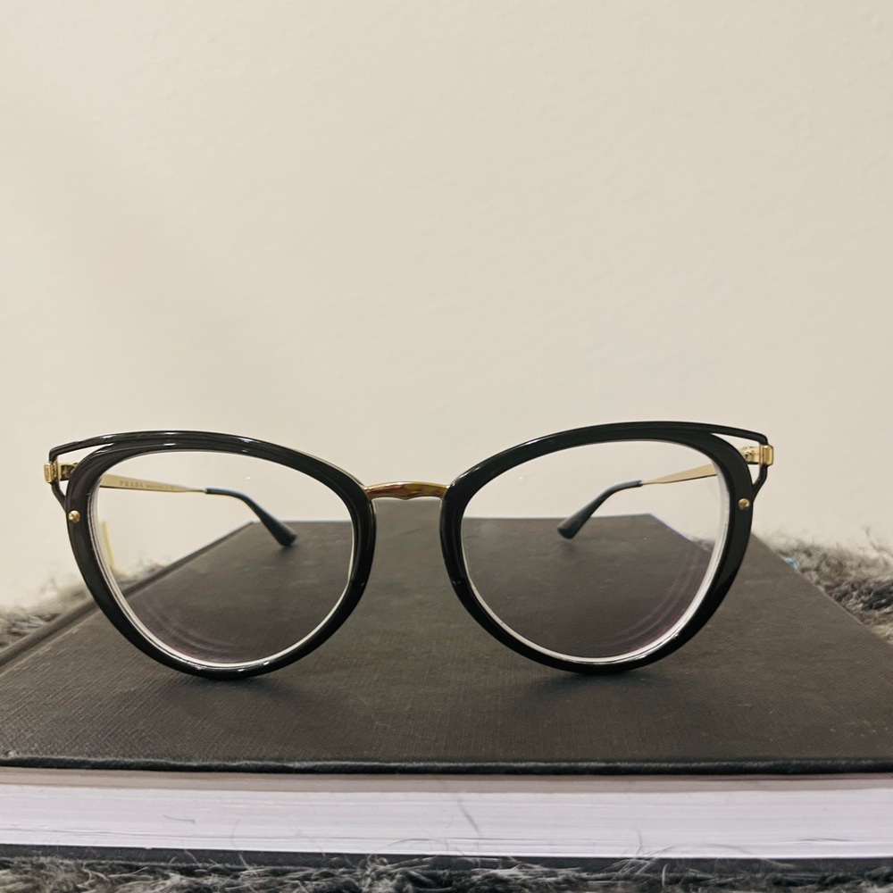 Stunning Prada eyewear featuring a sleek black and gold frame. #glasses #prada